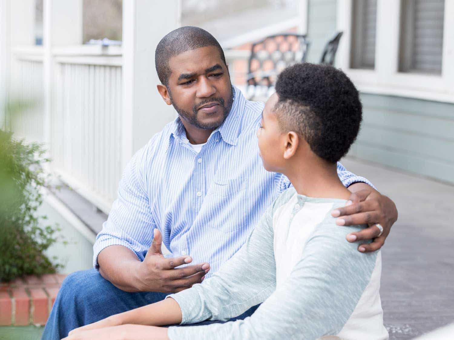 Черный отец. Black father and son. African American man child. Father teenage son. Father talking to son.